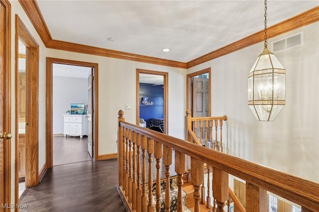 1101 Partridge Dr, Wadsworth, OH 44281 - corridor featuring an upstairs landing, dark wood finished floors, ornamental molding, and a chandelier