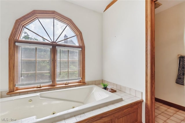 1101 Partridge Dr, Wadsworth, OH 44281 - bathroom with plenty of natural light, a jetted tub, and tile patterned flooring