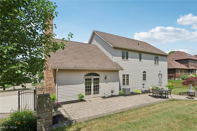 1101 Partridge Dr, Wadsworth, OH 44281 - rear view of property with a yard, a patio, a shingled roof, a chimney, and french doors
