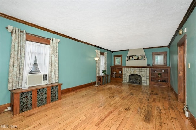 517 Broad Ave NW, Canton, OH 44708 - unfurnished living room with hardwood / wood-style flooring, ornamental molding, a fireplace, and cooling unit