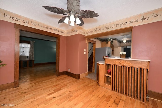 517 Broad Ave NW, Canton, OH 44708 - unfurnished living room featuring hardwood / wood-style flooring, ceiling fan, and stairway