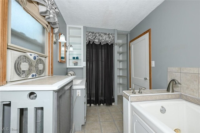 517 Broad Ave NW, Canton, OH 44708 - bathroom with a garden tub, tile patterned floors, and a textured ceiling