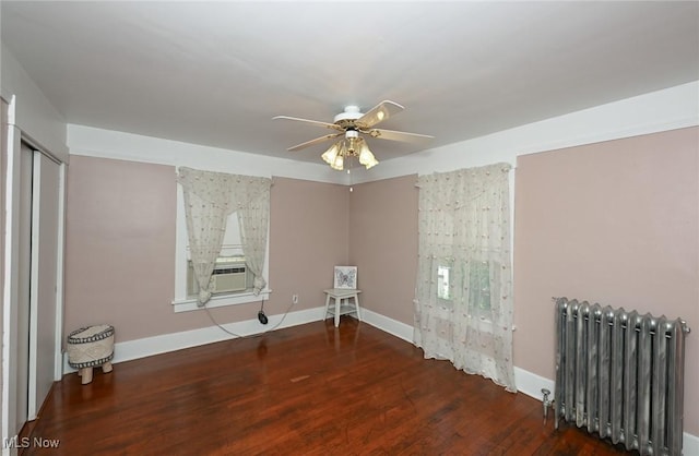 517 Broad Ave NW, Canton, OH 44708 - empty room with radiator heating unit, wood finished floors, a ceiling fan, and cooling unit