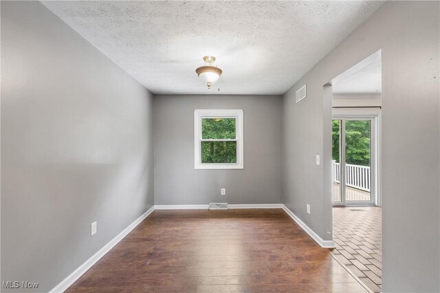 254 Eastern Rd, Doylestown, OH 44230 - spare room featuring wood finished floors and a textured ceiling