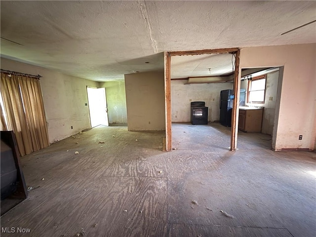 3066 State Route 7 N, Pierpont, OH 44082 - unfurnished living room with a wood stove