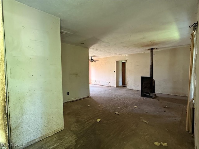 3066 State Route 7 N, Pierpont, OH 44082 - unfurnished living room with a wood stove
