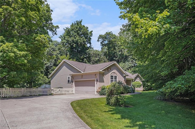 11801 Quail Crest Ave, Mantua, OH 44255 - view of front of home featuring driveway, stucco siding, and an attached garage
