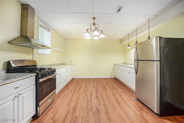 11801 Quail Crest Ave, Mantua, OH 44255 - kitchen featuring stainless steel appliances, wall chimney range hood, light wood-style floors, white cabinets, and a drop ceiling
