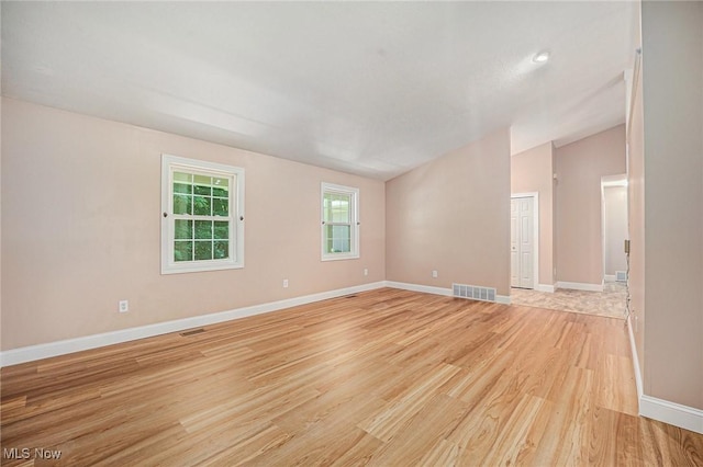 11801 Quail Crest Ave, Mantua, OH 44255 - spare room with light wood-style flooring and lofted ceiling