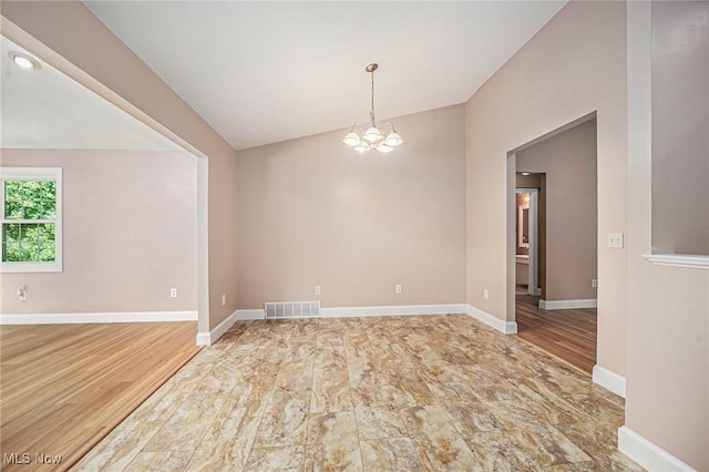 11801 Quail Crest Ave, Mantua, OH 44255 - empty room featuring lofted ceiling and a chandelier