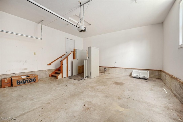 11801 Quail Crest Ave, Mantua, OH 44255 - garage with wainscoting and a garage door opener