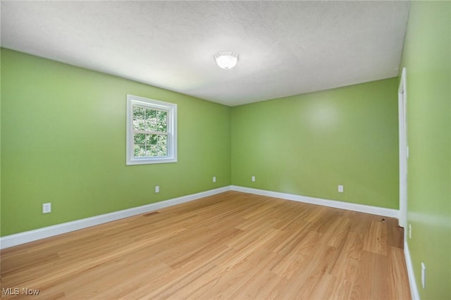 11801 Quail Crest Ave, Mantua, OH 44255 - empty room featuring light wood finished floors and baseboards