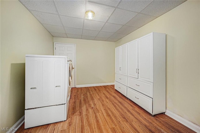 11801 Quail Crest Ave, Mantua, OH 44255 - unfurnished bedroom with washer / dryer, light wood-type flooring, and a drop ceiling