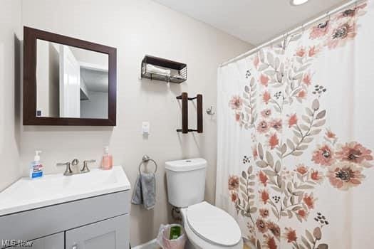 1932 Pinewood Ln, Painesville, OH 44077 - full bathroom featuring vanity and a shower with shower curtain