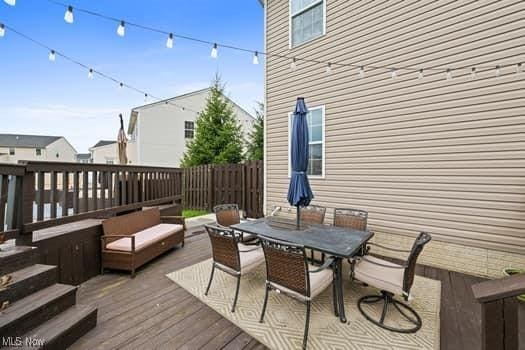 1932 Pinewood Ln, Painesville, OH 44077 - wooden terrace featuring outdoor dining area and an outdoor living space