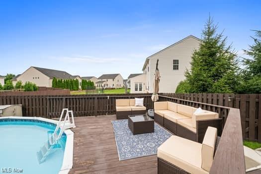 1932 Pinewood Ln, Painesville, OH 44077 - view of swimming pool featuring outdoor lounge area, a deck, and a residential view