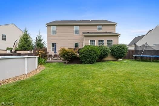 1932 Pinewood Ln, Painesville, OH 44077 - rear view of house featuring a trampoline and an outdoor pool