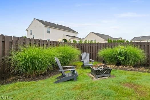1932 Pinewood Ln, Painesville, OH 44077 - fenced backyard featuring a fire pit