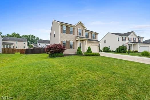 1932 Pinewood Ln, Painesville, OH 44077 - view of front of home with concrete driveway and an attached garage