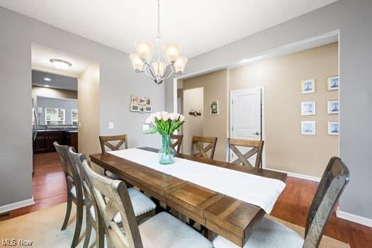 1932 Pinewood Ln, Painesville, OH 44077 - dining space with a chandelier and wood finished floors
