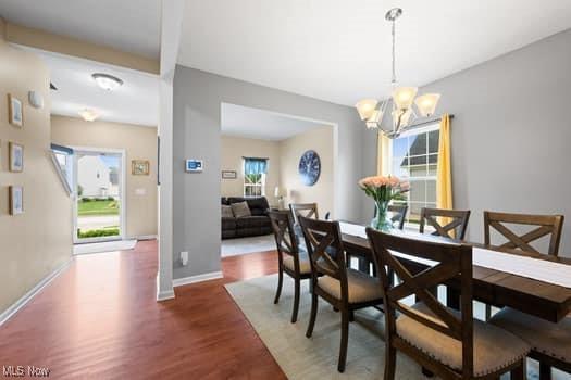 1932 Pinewood Ln, Painesville, OH 44077 - dining area with wood finished floors and a chandelier