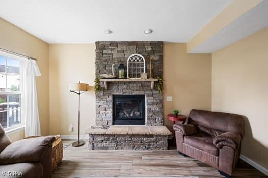 1932 Pinewood Ln, Painesville, OH 44077 - living area featuring a fireplace and wood finished floors