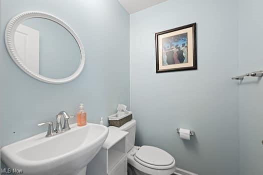 1932 Pinewood Ln, Painesville, OH 44077 - half bath featuring a sink and toilet
