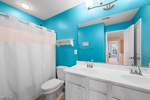 1932 Pinewood Ln, Painesville, OH 44077 - full bathroom with double vanity and a shower with shower curtain