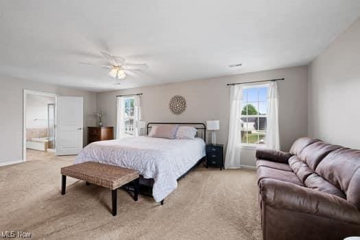 1932 Pinewood Ln, Painesville, OH 44077 - bedroom with carpet, ceiling fan, and ensuite bath