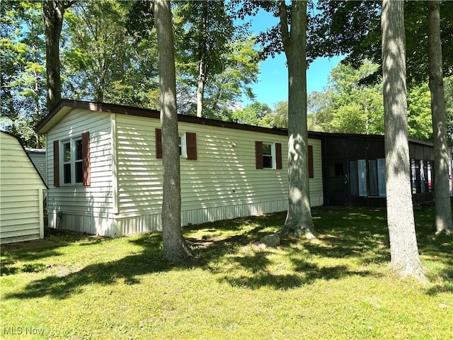 1229 Columbiana Lisbon Rd Unit 104, Columbiana, OH 44408 - view of side of property featuring a lawn