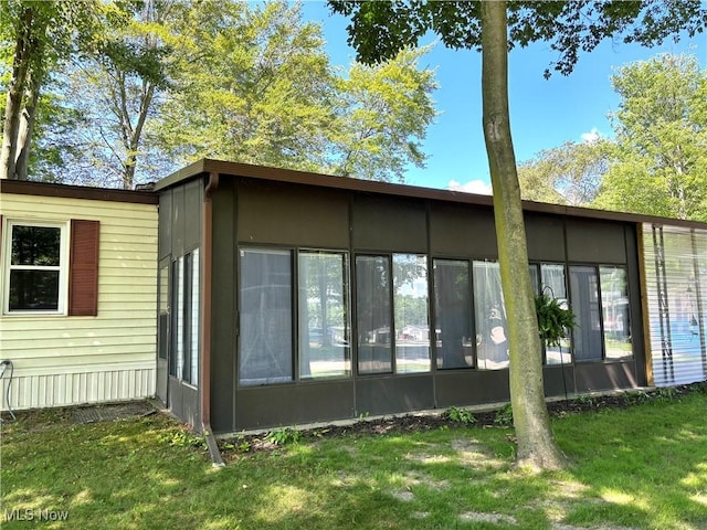 1229 Columbiana Lisbon Rd Unit 104, Columbiana, OH 44408 - back of house with a sunroom and a yard