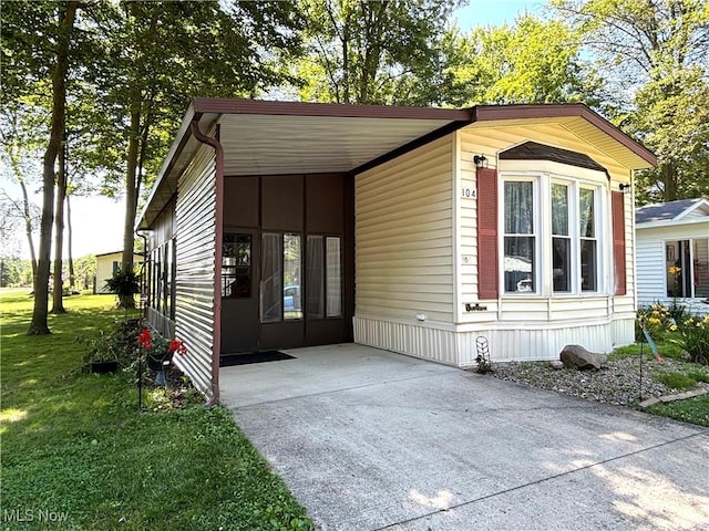 1229 Columbiana Lisbon Rd Unit 104, Columbiana, OH 44408 - view of front of home featuring driveway, a carport, and a front lawn