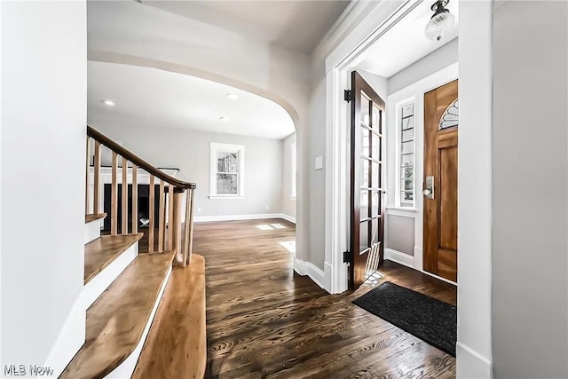 1348 W Erie Ave, Lorain, OH 44052 - foyer with arched walkways, dark wood finished floors, stairway, and recessed lighting