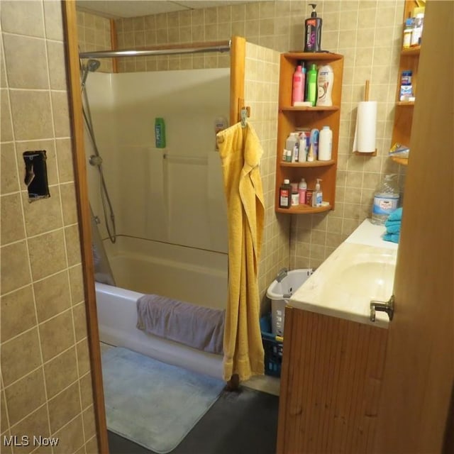 4018 Steubenville Rd SE, Amsterdam, OH 43903 - bathroom featuring tile walls, vanity, and shower / bathtub combination with curtain