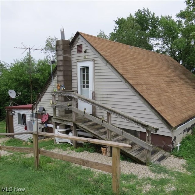 4018 Steubenville Rd SE, Amsterdam, OH 43903 - view of property exterior featuring roof with shingles and a chimney