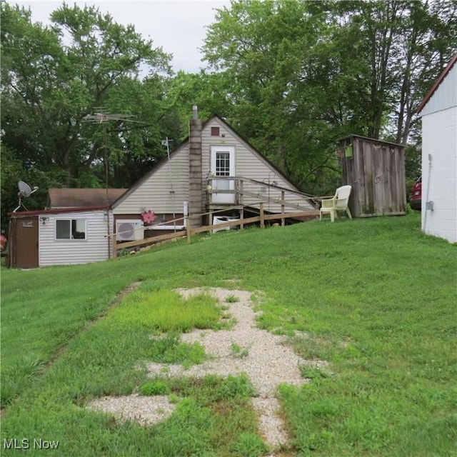 4018 Steubenville Rd SE, Amsterdam, OH 43903 - view of grassy yard featuring a storage unit and view of wooded area