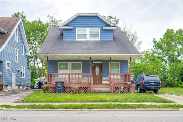 12826 Harvard Ave, Cleveland, OH 44105 - bungalow-style house featuring covered porch, roof with shingles, a front yard, and driveway
