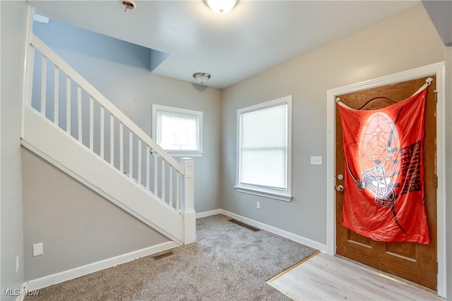 12826 Harvard Ave, Cleveland, OH 44105 - carpeted entryway with stairway and baseboards