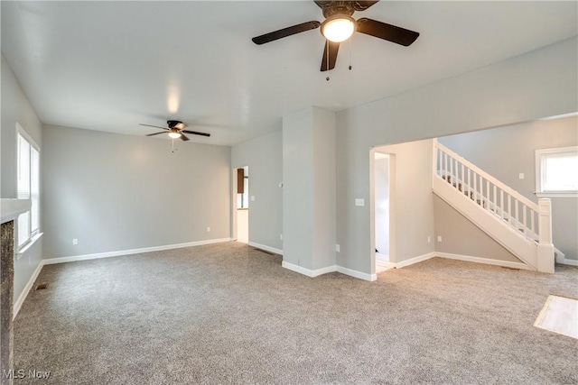 12826 Harvard Ave, Cleveland, OH 44105 - unfurnished living room with ceiling fan, carpet floors, stairway, and a premium fireplace