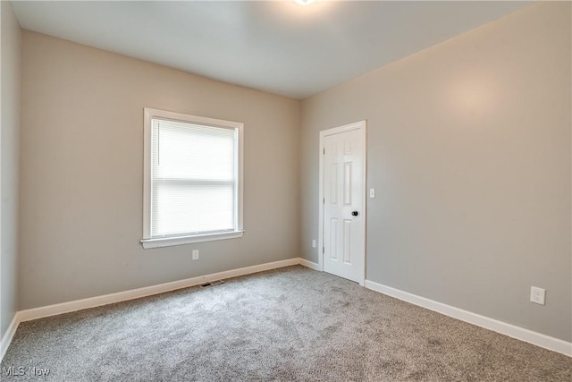 12826 Harvard Ave, Cleveland, OH 44105 - carpeted empty room with baseboards
