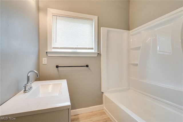 12826 Harvard Ave, Cleveland, OH 44105 - bathroom featuring vanity, shower / washtub combination, and wood finished floors