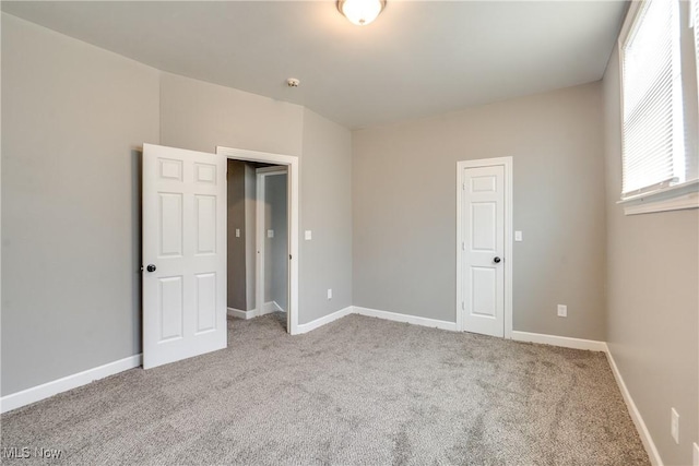 12826 Harvard Ave, Cleveland, OH 44105 - unfurnished bedroom with carpet floors and baseboards