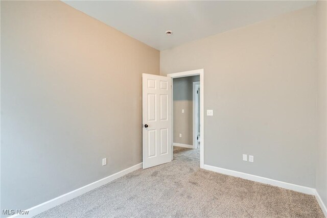 12826 Harvard Ave, Cleveland, OH 44105 - empty room with light colored carpet and fire sprinkler in ceiling