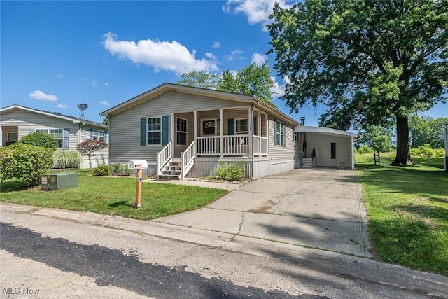 19 Pageant Ln, Olmsted Twp, OH 44138 - manufactured / mobile home with covered porch, a front lawn, and concrete driveway