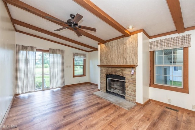 19 Pageant Ln, Olmsted Twp, OH 44138 - unfurnished living room featuring a stone fireplace, wood finished floors, and a ceiling fan