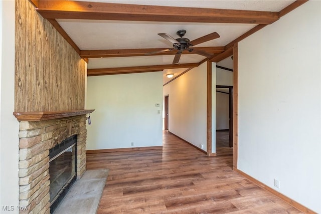 19 Pageant Ln, Olmsted Twp, OH 44138 - unfurnished living room featuring beam ceiling, a ceiling fan, a fireplace, and wood finished floors