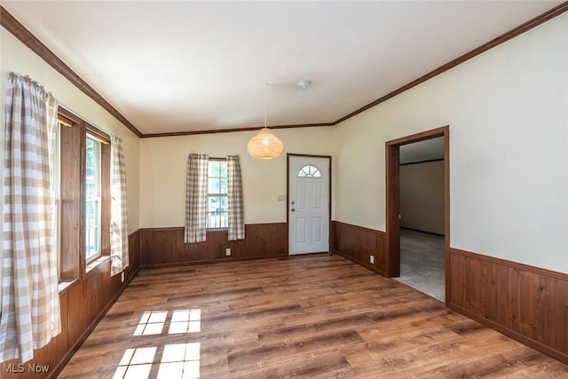 19 Pageant Ln, Olmsted Twp, OH 44138 - spare room featuring a wainscoted wall, wood walls, wood finished floors, and crown molding