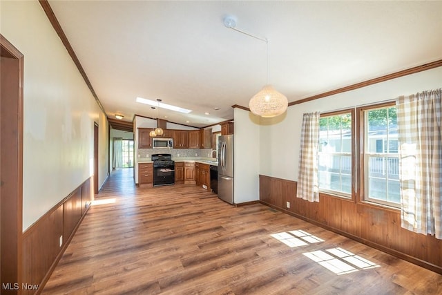 19 Pageant Ln, Olmsted Twp, OH 44138 - kitchen with stainless steel appliances, ornamental molding, wood finished floors, light countertops, and wainscoting