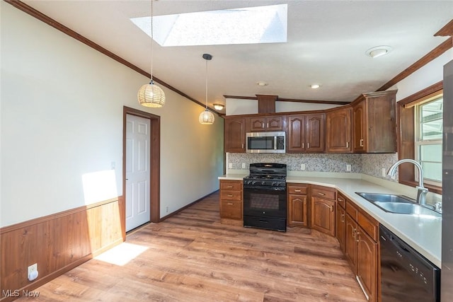 19 Pageant Ln, Olmsted Twp, OH 44138 - kitchen with black appliances, a skylight, crown molding, light countertops, and light wood-type flooring