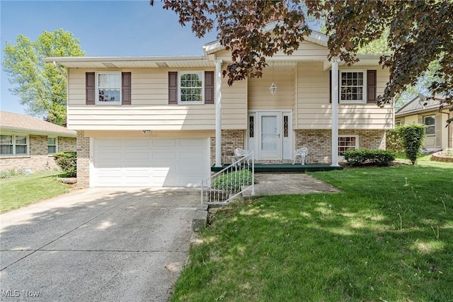 530 N Scranton St, Ravenna, OH 44266 - split foyer home featuring a garage, brick siding, concrete driveway, and a front lawn